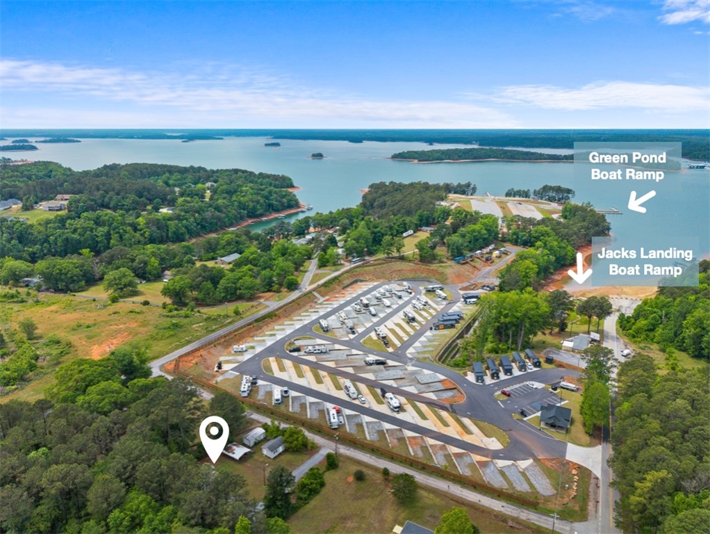 111 State Rd S-4-104 Anderson, SC 29626 - Photo 2 of 42 An aerial view captures the vastness of a lake surrounded by lush green landscapes and double boat ramps.