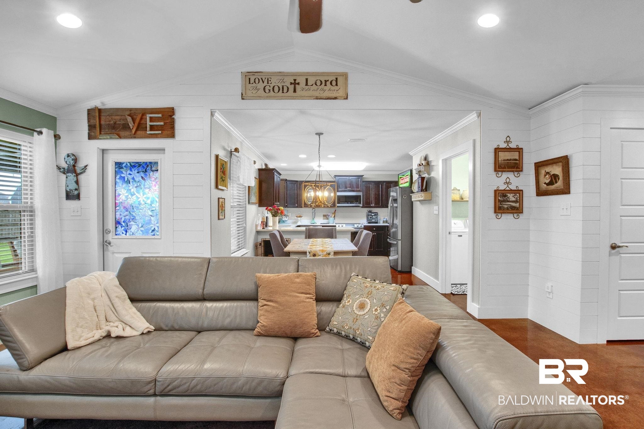 203 Lakefront Circle Summerdale, AL 36580 - Photo 16 of 69 Living room with wooden walls, lofted ceiling, and crown molding