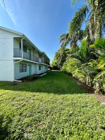 a house with green field in front of it
