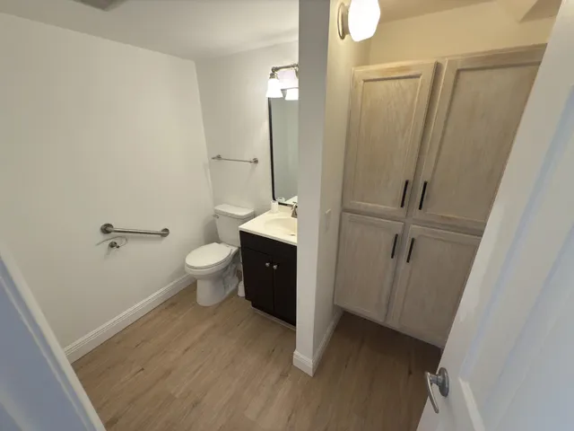 a bathroom with a granite countertop sink toilet and shower