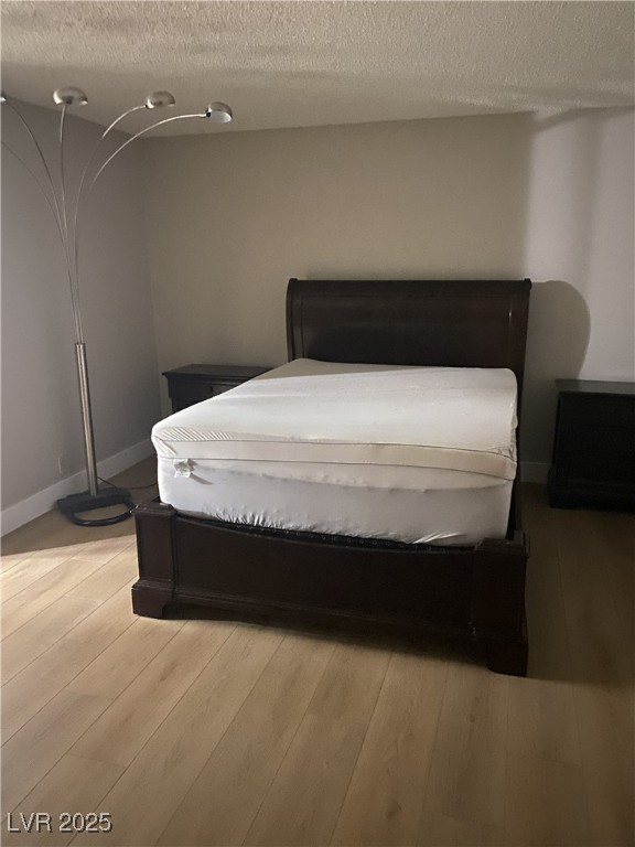 750 South Royal Crest Circle, Unit 342 Las Vegas, NV 89169 - Photo 18 of 21 Bedroom with a textured ceiling and light wood-style flooring