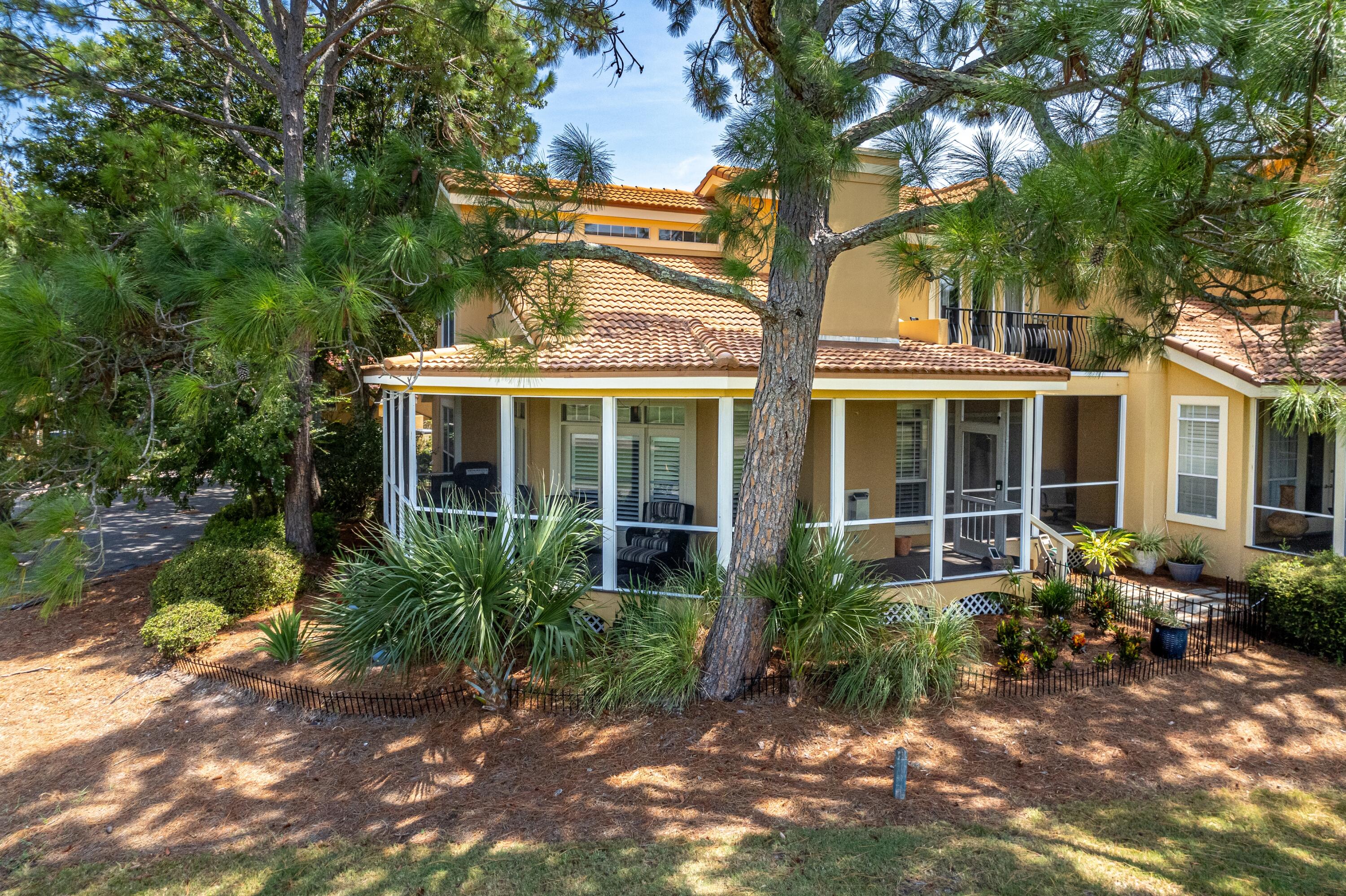 51 Vantage Point Miramar Beach, FL 32550 - Photo 30 of 64 a view of a house with brick walls plants and large tree