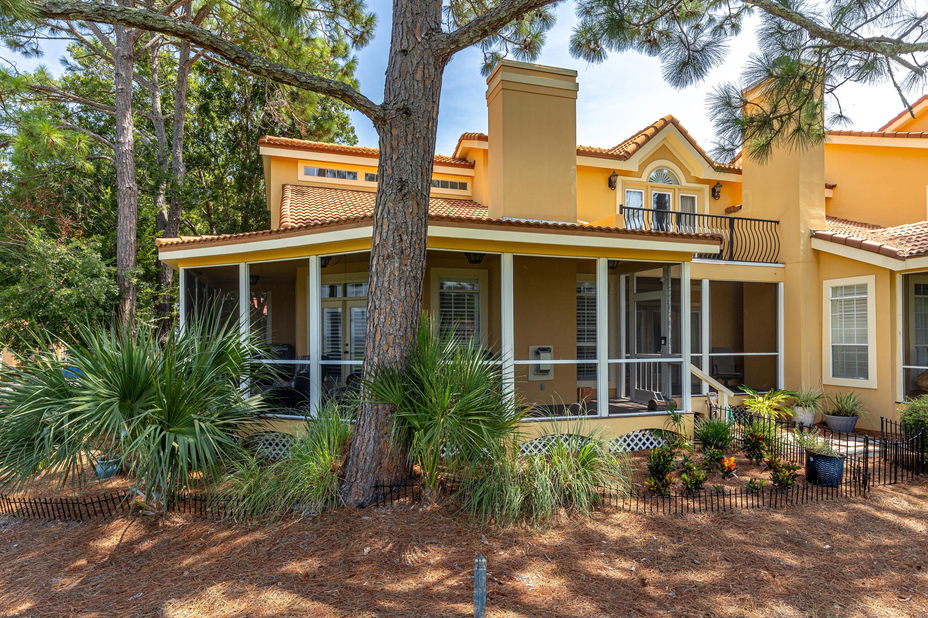 51 Vantage Point Miramar Beach, FL 32550 - Photo 4 of 64 front view of a house with potted plants and a bench