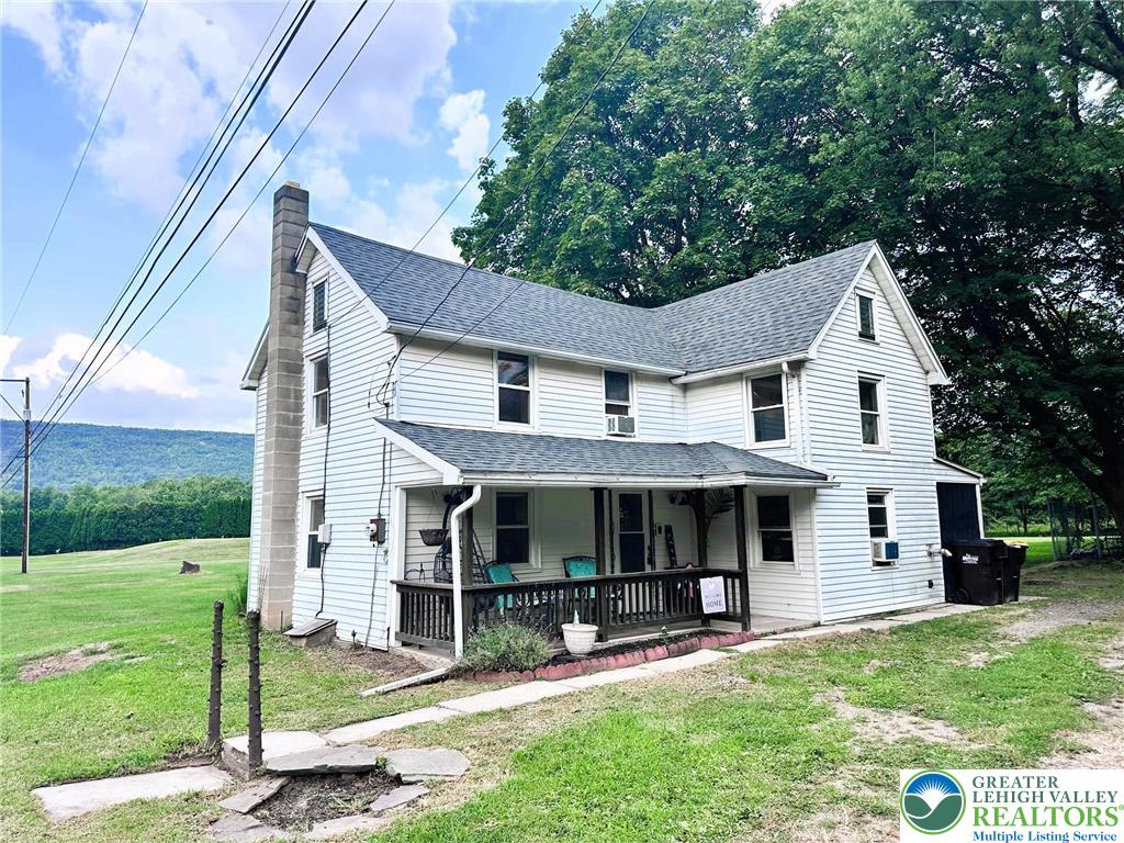 a front view of a house with a yard and porch