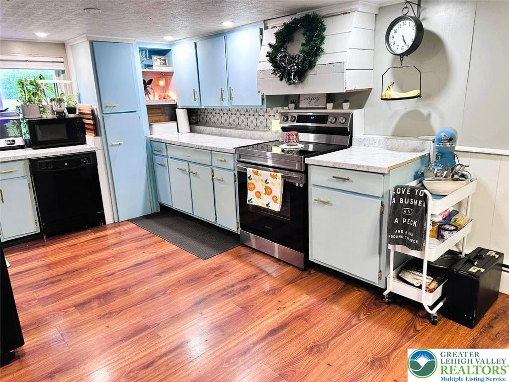 1250 Myrtle Road Walnutport, PA 18088 - Photo 3 of 30 a kitchen with stainless steel appliances granite countertop a stove top oven a refrigerator a sink and dishwasher with wooden floor