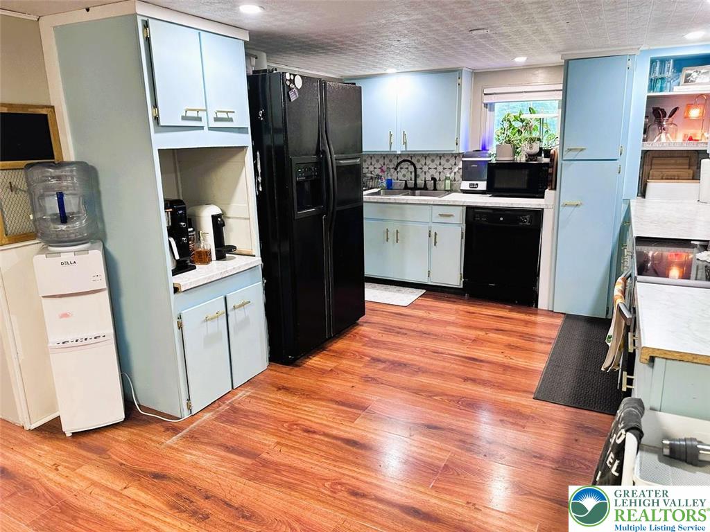 1250 Myrtle Road Walnutport, PA 18088 - Photo 4 of 30 a kitchen with stainless steel appliances a stove top oven a refrigerator a sink and dishwasher with wooden floor