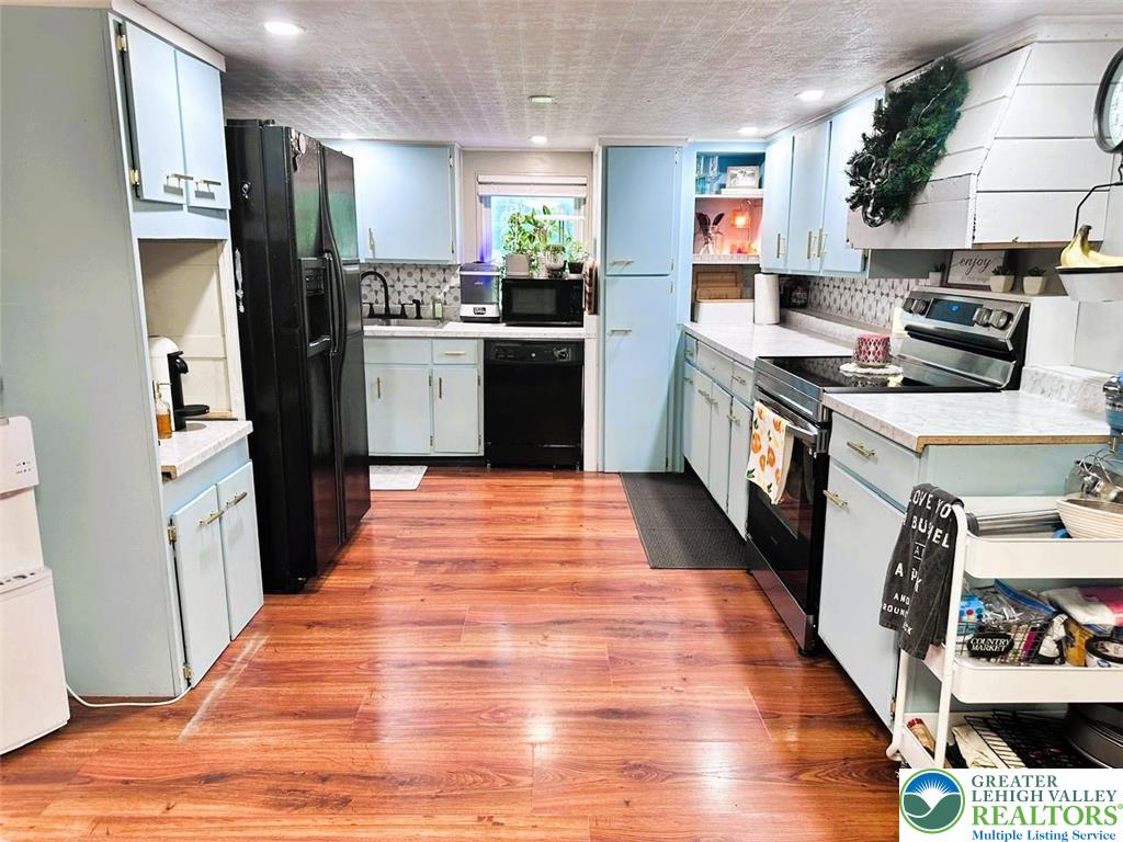 1250 Myrtle Road Walnutport, PA 18088 - Photo 7 of 30 a kitchen with stainless steel appliances a stove top oven a refrigerator a sink and dishwasher with wooden floor