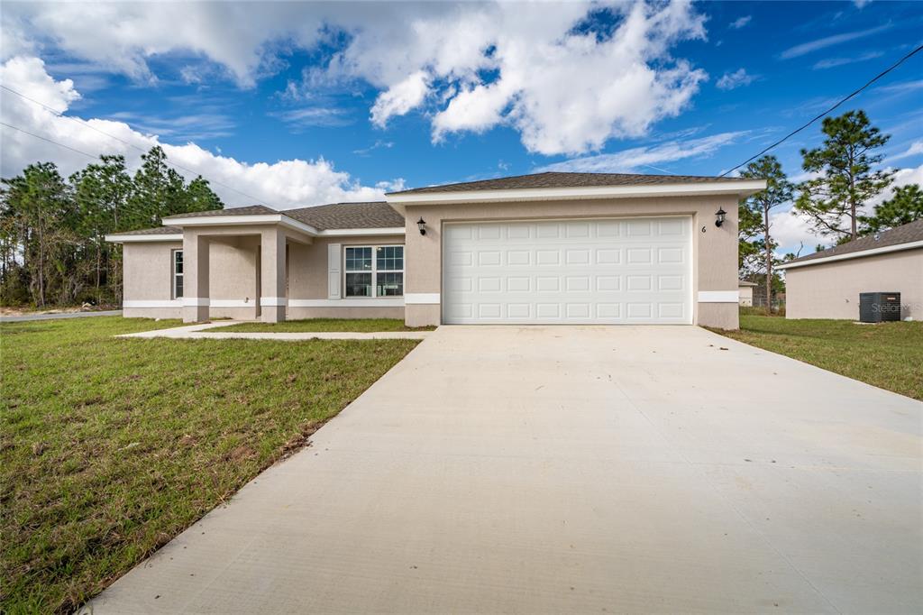 412 Water Road Ocala, FL 34472 - Photo 1 of 1 a front view of a house with a garden and yard