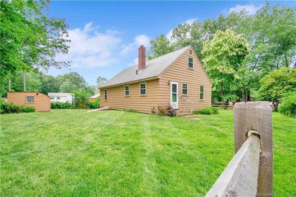 137 Edgemere Road Coventry, CT 06238 - Photo 1 of 1 a backyard of a house with plants and large tree