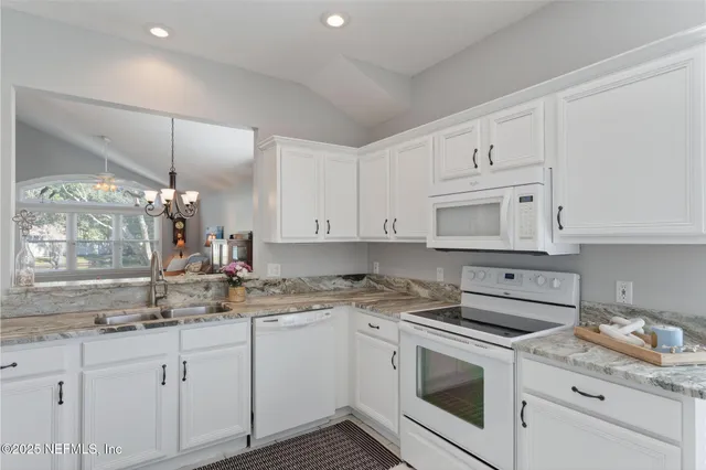 a kitchen with appliances cabinets and a sink