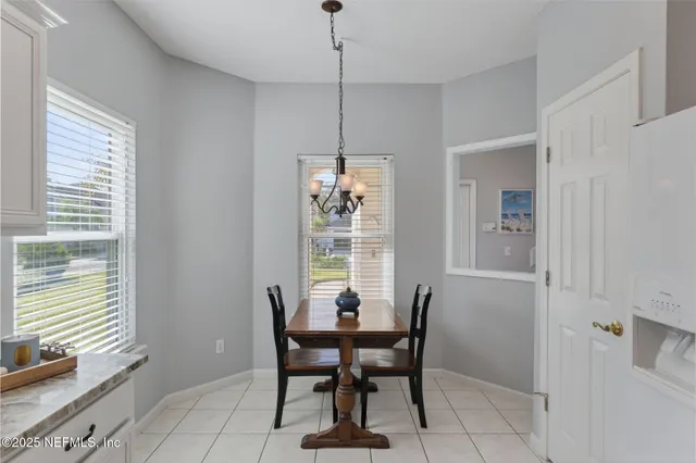a dining room with furniture and window