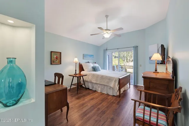 a spacious bedroom with a bed and a chandelier