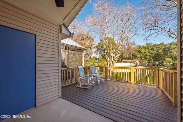 a view of a chair and tables in the balcony