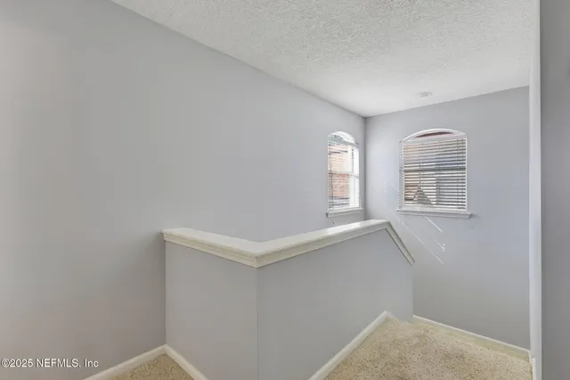 a view of an empty room with windows