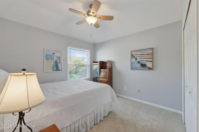 a bedroom with a bed and a lamp