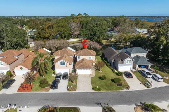 an aerial view of residential houses with outdoor space