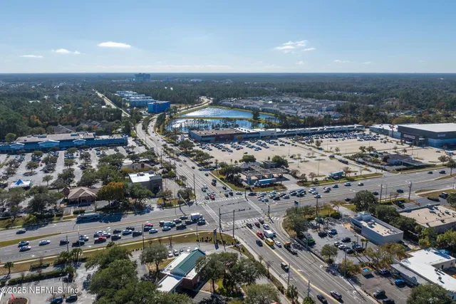an aerial view of residential houses with outdoor space and river
