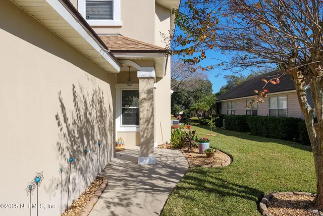 a view of a house with backyard and sitting area