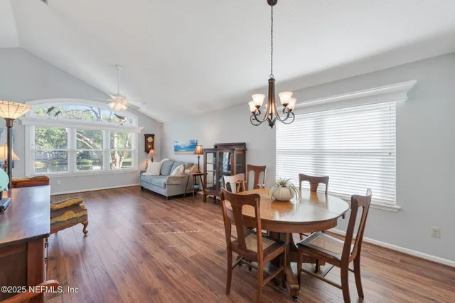 a view of a dining room with furniture window and wooden floor