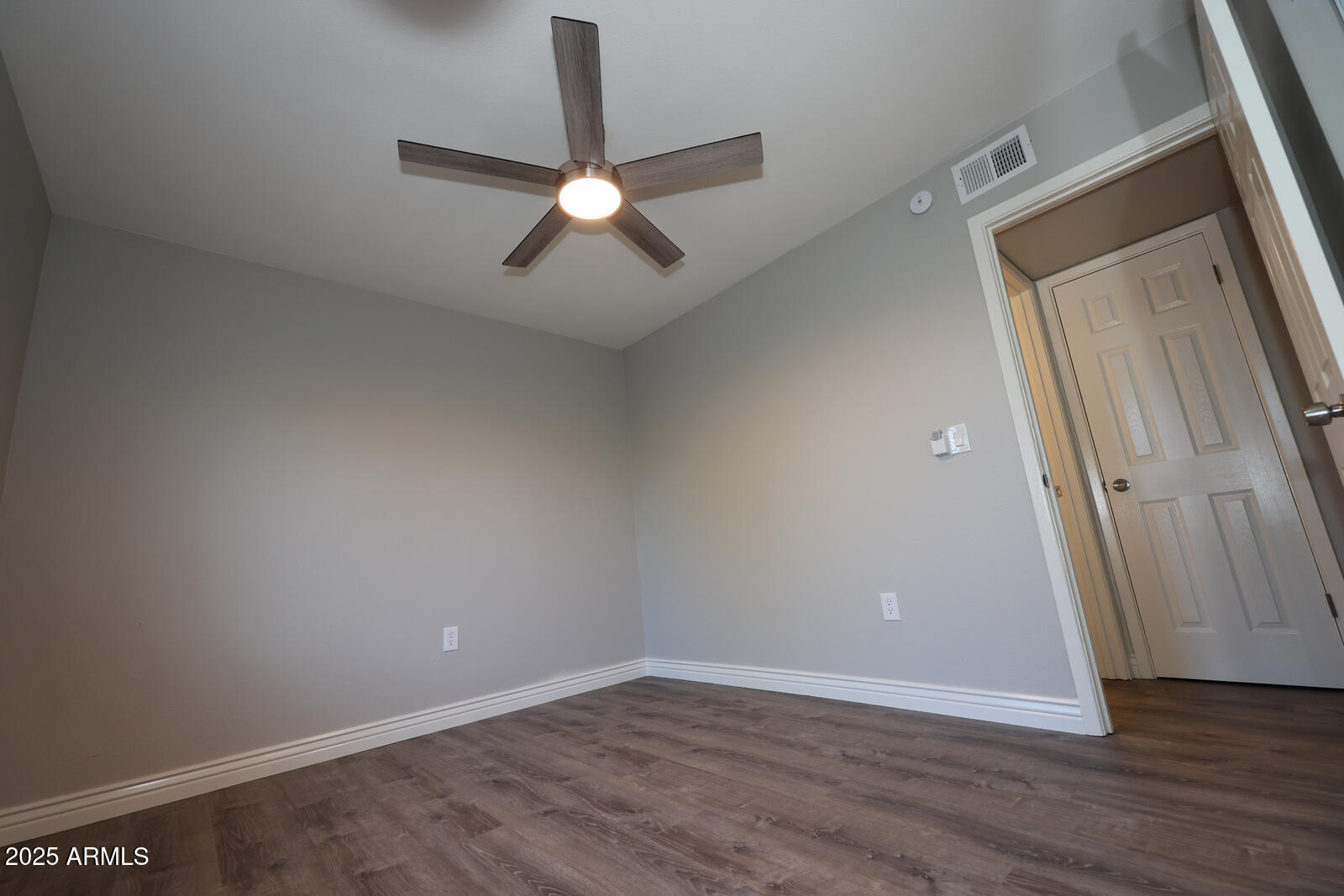 127 South Outpost Road, Unit 2 Apache Junction, AZ 85119 - Photo 7 of 14 an empty room with wooden floor and fan