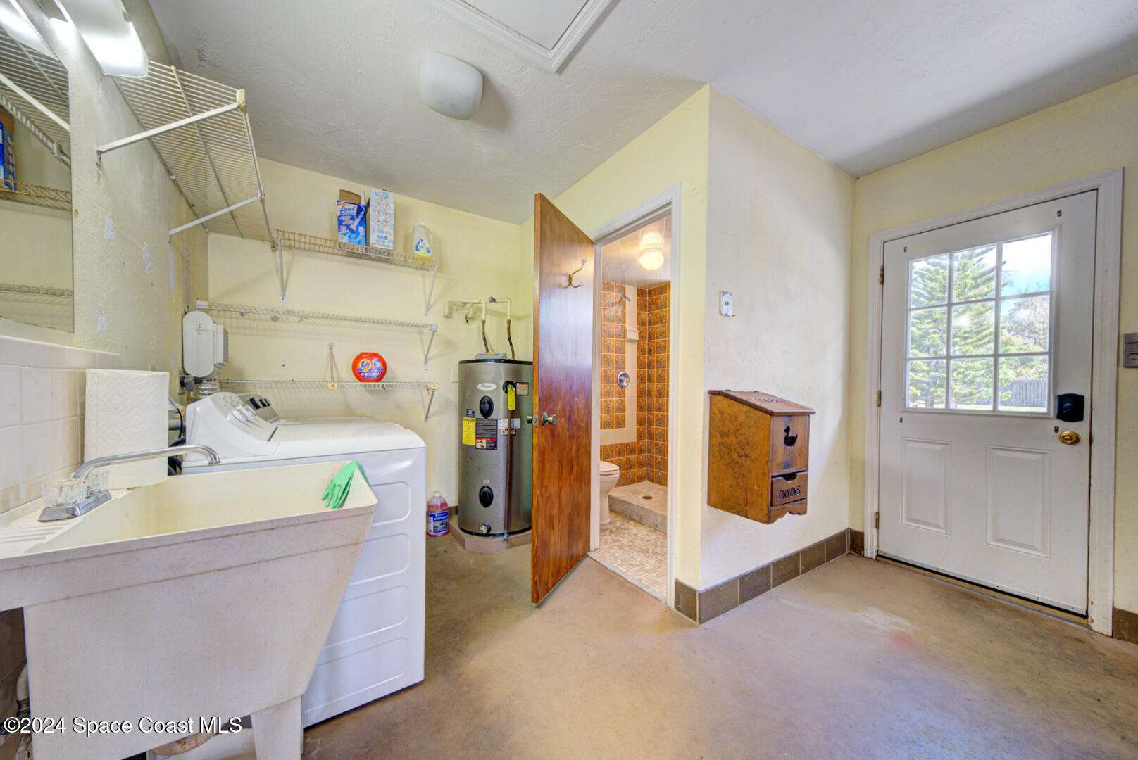 4050 Quail Path Road Cocoa, FL 32926 - Photo 48 of 60 laundry area & garage bathroom