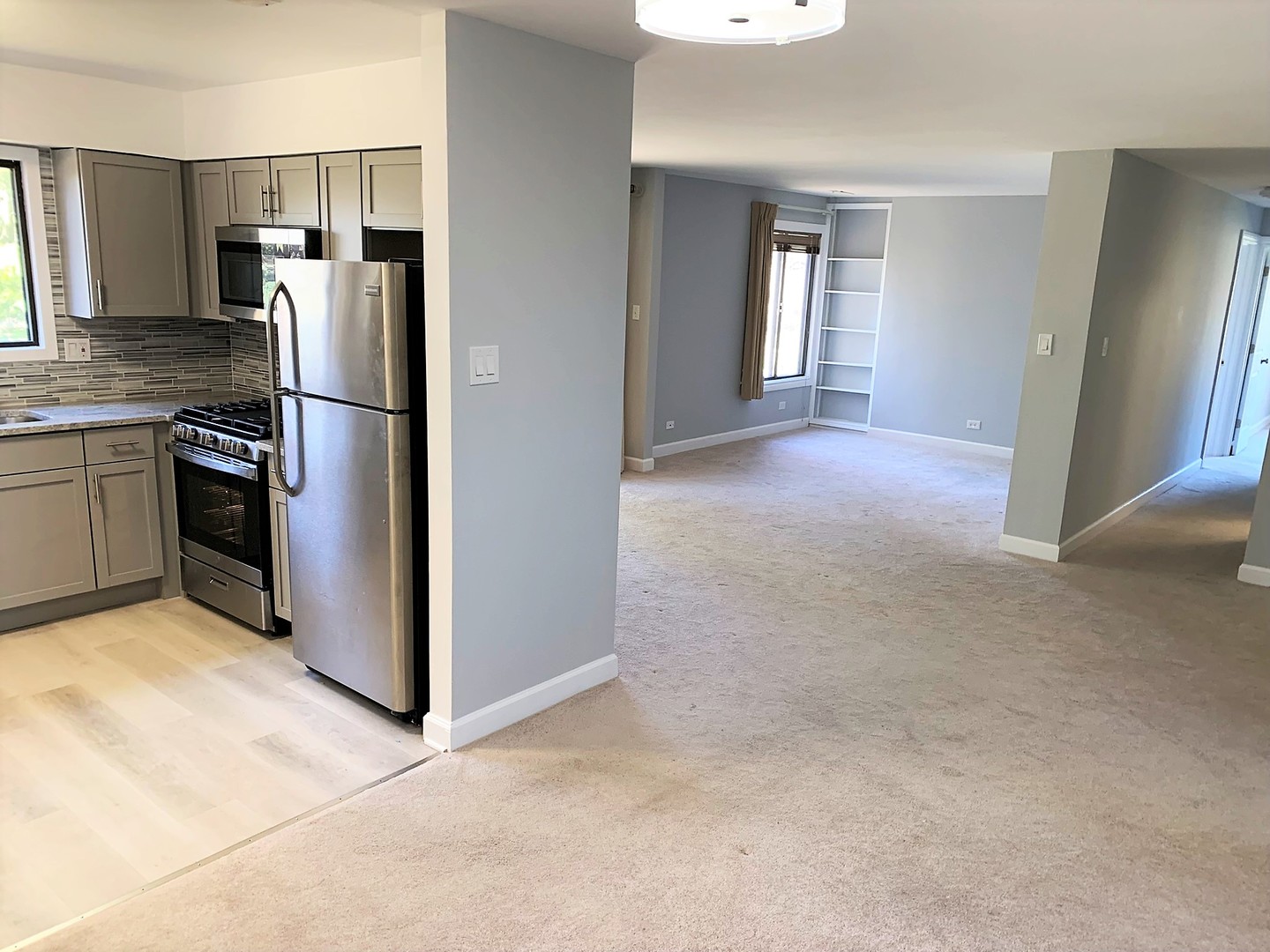 1741 Harrow Court, Unit B Wheaton, IL 60189 - Photo 4 of 24 a kitchen with stainless steel appliances granite countertop a refrigerator and a stove top oven