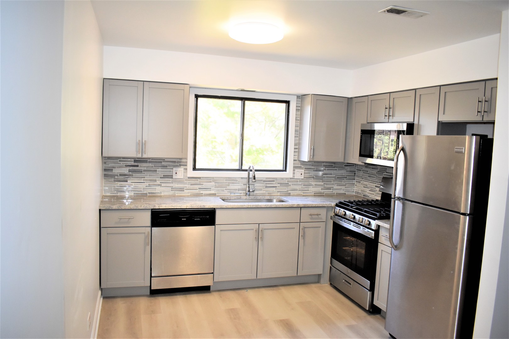 1741 Harrow Court, Unit B Wheaton, IL 60189 - Photo 10 of 24 a kitchen with a white cabinets and white stainless steel appliances
