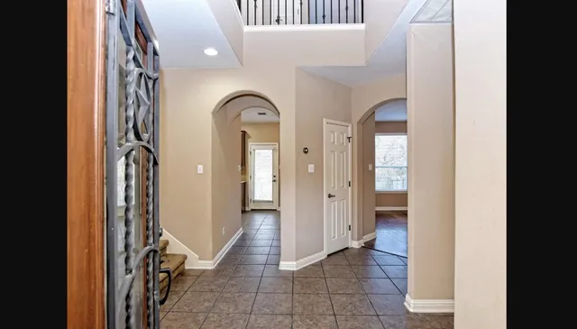 a view of a hallway with wooden shelves