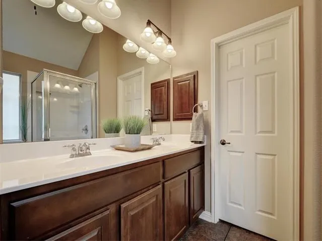 a bathroom with a double vanity sink and a mirror