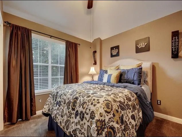a bed sitting in a bedroom next to a window