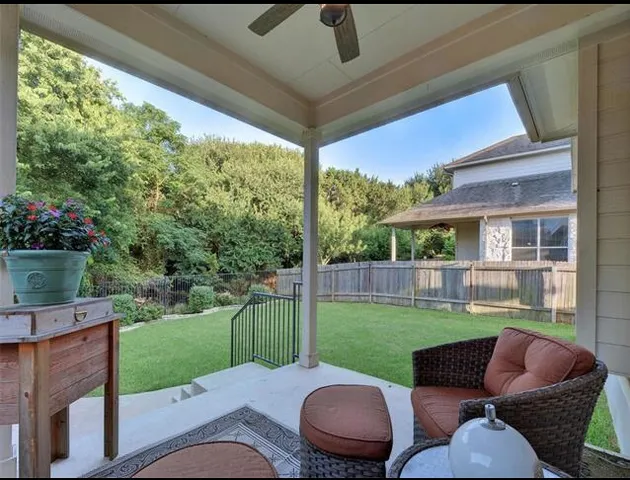 a backyard of a house with yard table and chairs