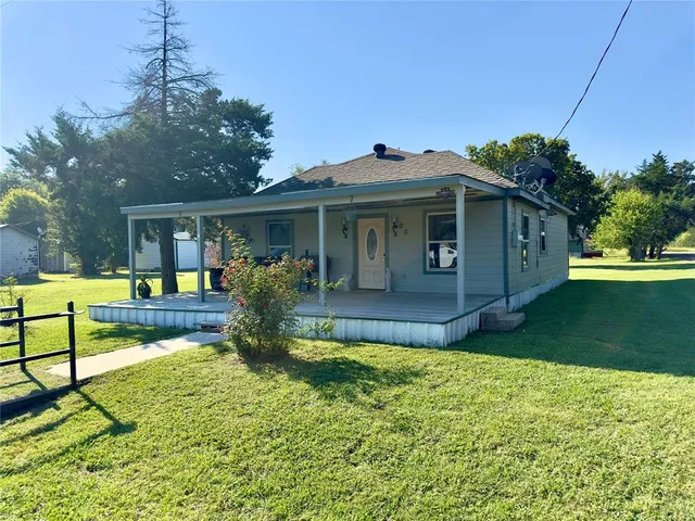 a view of a house with backyard and sitting area