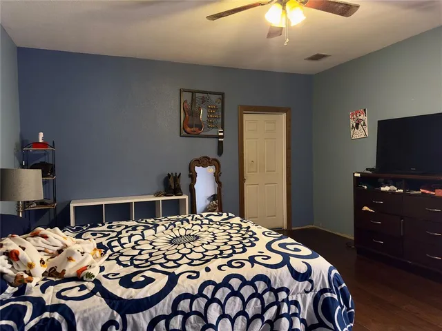 a bedroom with a bed and a television