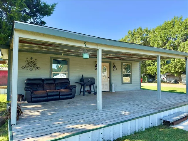 a view of backyard with swimming pool and outdoor seating