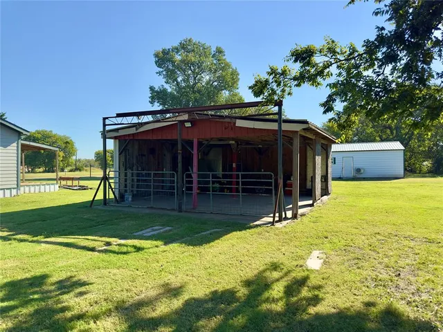 a view of a house with a yard and sitting area