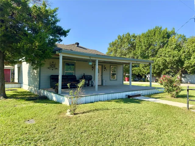 a view of a house with swimming pool and porch with furniture