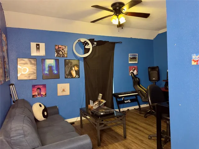 a living room with furniture and wooden floor