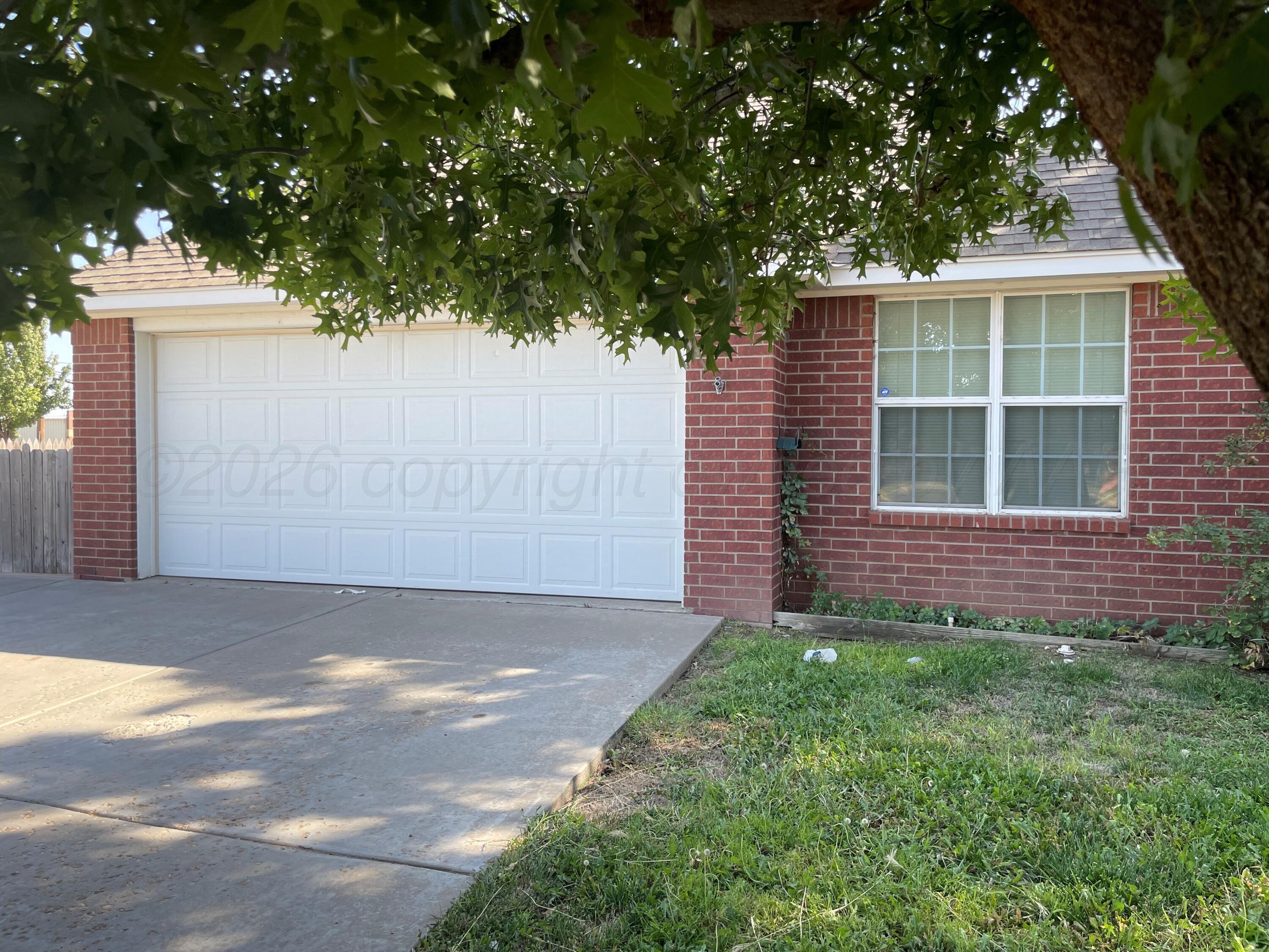 6001 Estacado Lane Amarillo, TX 79109 - Photo 1 of 21 a front view of a house with a garden