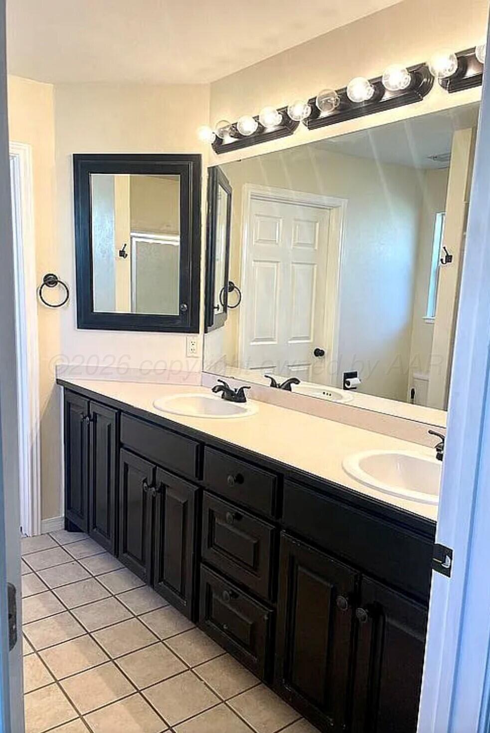 6001 Estacado Lane Amarillo, TX 79109 - Photo 12 of 21 a bathroom with a double vanity sink and a mirror