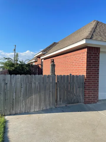 a front view of a house with a fence