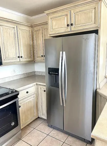 a kitchen with stainless steel appliances granite countertop a refrigerator and a stove top oven