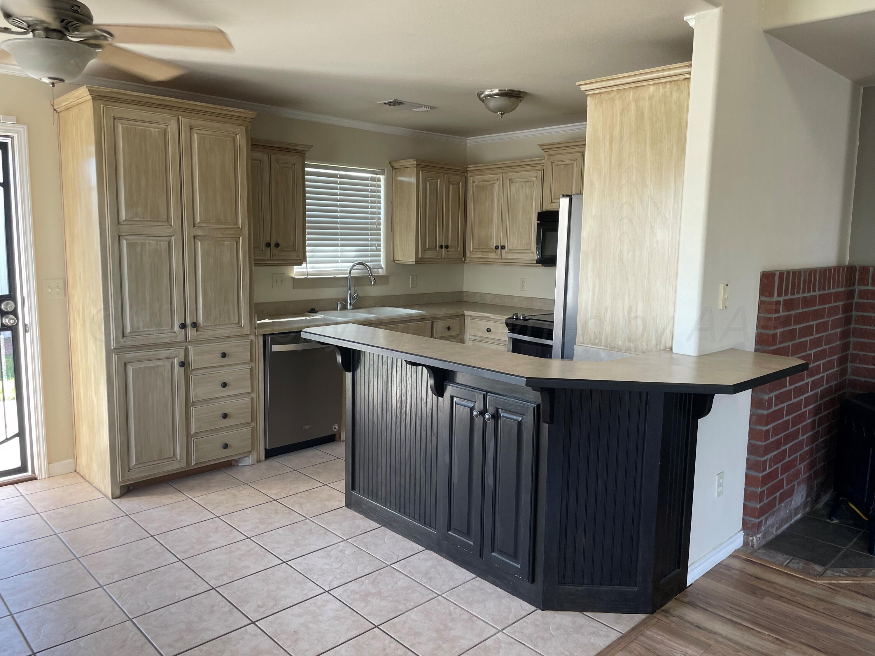 6001 Estacado Lane Amarillo, TX 79109 - Photo 8 of 21 a kitchen with a stove a sink and a refrigerator