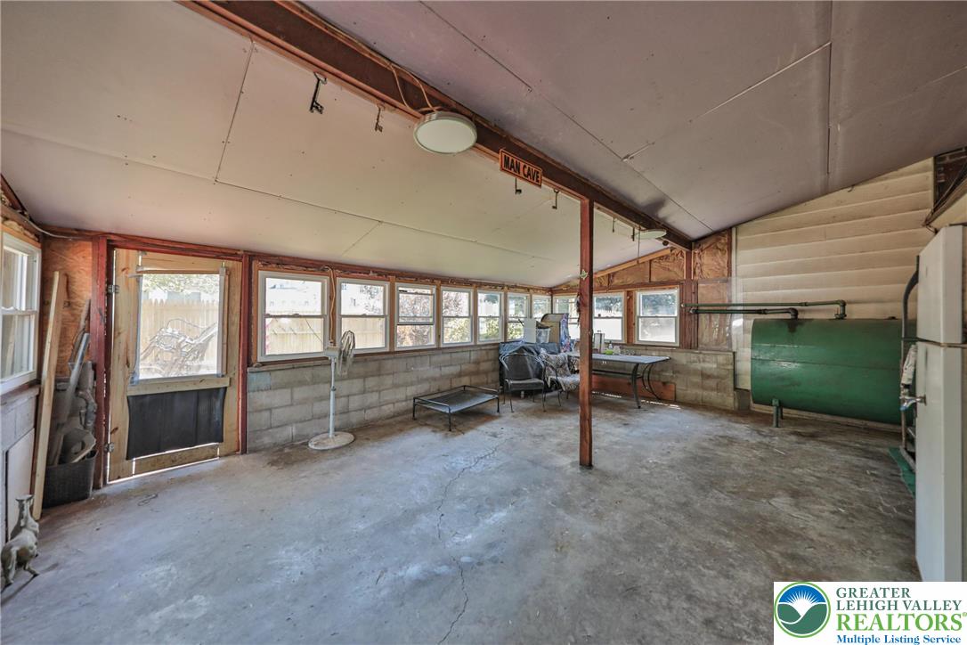 417 3rd Street Lehighton, PA 18235 - Photo 39 of 39 This spacious, enclosed porch offers ample natural illumination and a concrete floor, perfect for diverse uses.