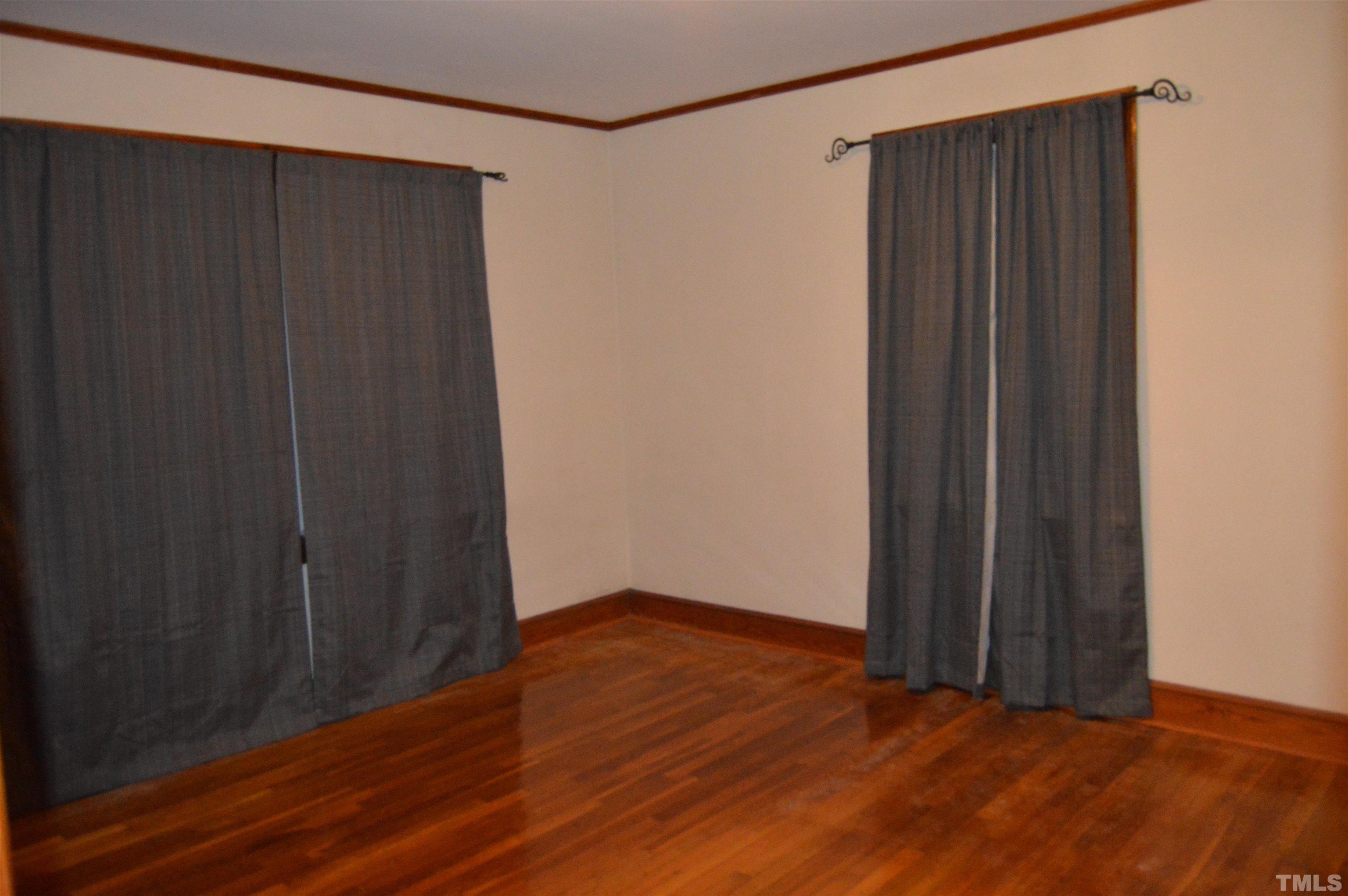 853 Lucy Garrett Road Roxboro, NC 27574 - Photo 8 of 9 a view of an empty room with wooden floor