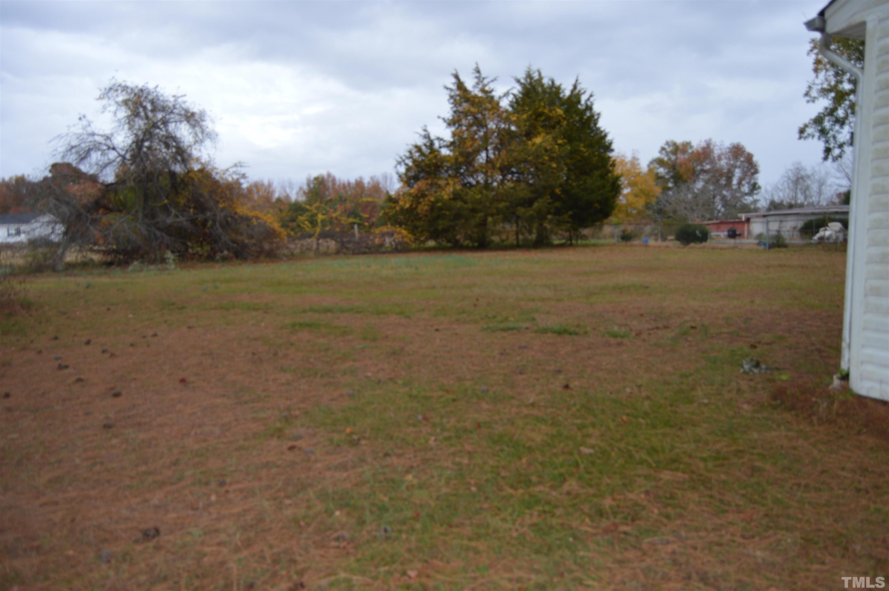 853 Lucy Garrett Road Roxboro, NC 27574 - Photo 9 of 9 a view of a field with trees in background
