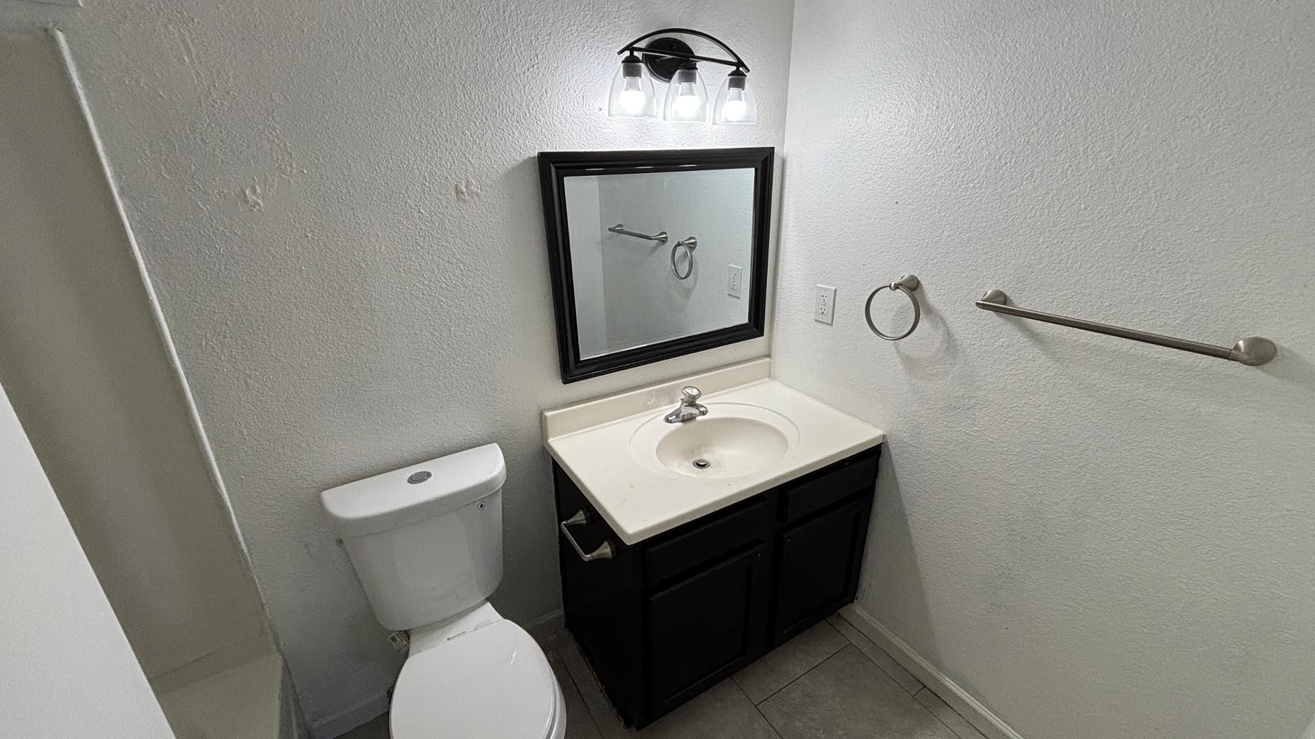 1130 East Butler Drive, Unit B4 Phoenix, AZ 85020 - Photo 16 of 17 a bathroom with a sink toilet and mirror