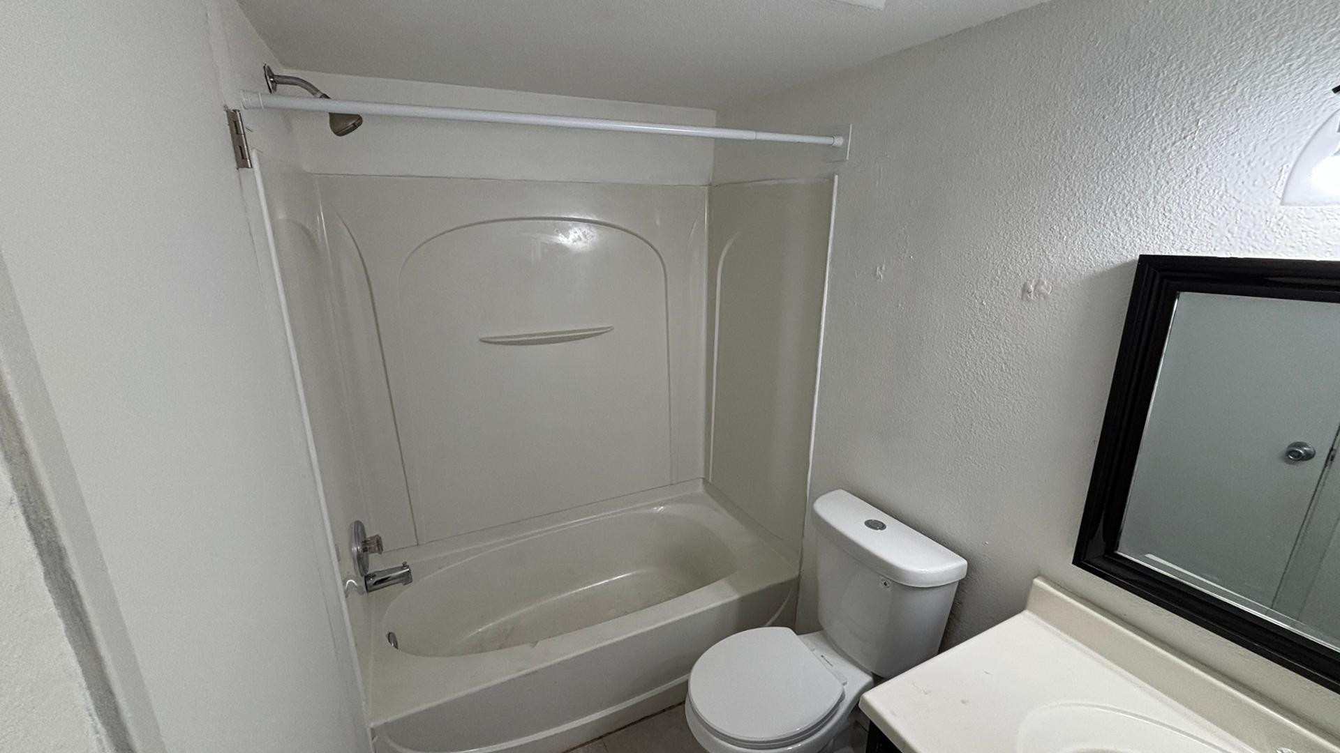 1130 East Butler Drive, Unit B4 Phoenix, AZ 85020 - Photo 17 of 17 a white toilet sitting next to a bath tub
