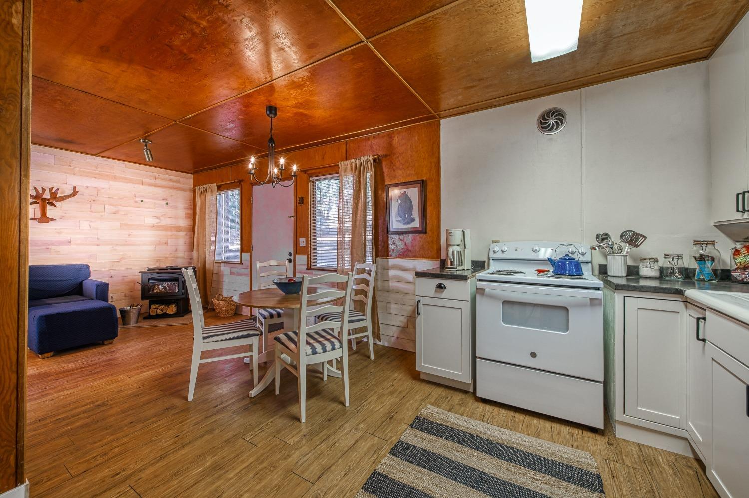 61347 Old Hunting Road Mono Hot Springs, CA 93634 - Photo 11 of 31 a kitchen with appliances cabinets and wooden floor