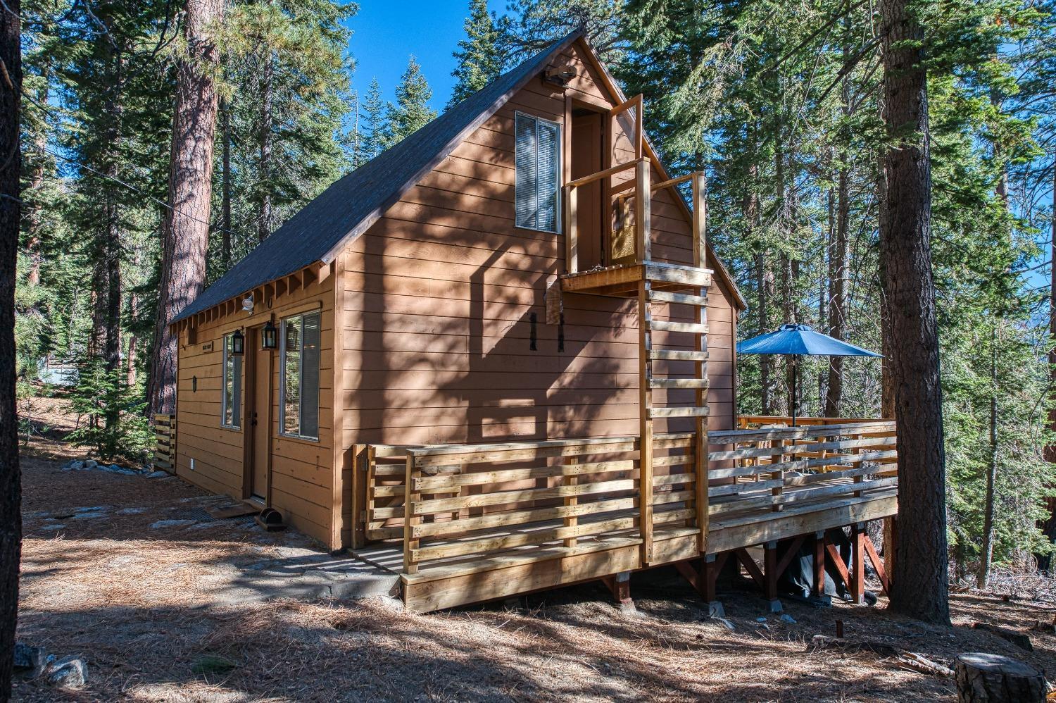 61347 Old Hunting Road Mono Hot Springs, CA 93634 - Photo 24 of 31 a view of wooden house with a large window and wooden fence