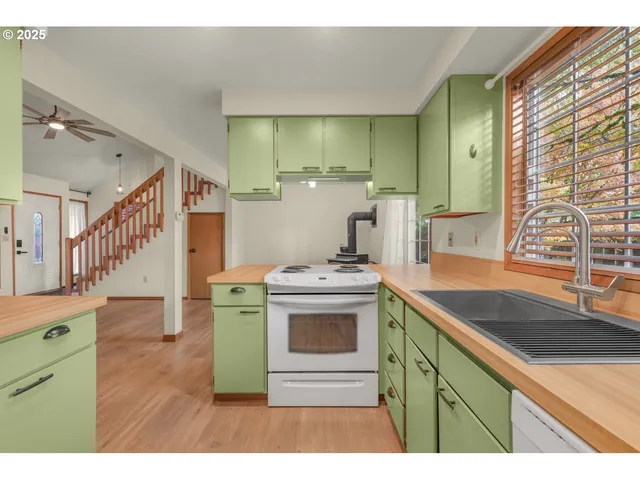 a kitchen with a stove a sink and a refrigerator